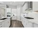 Bright kitchen with white cabinets, stainless steel appliances, and wood-look flooring at 5477 Wayfarer Ave, Apollo Beach, FL 33572