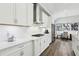 Kitchen with white cabinets, stainless steel appliances, granite countertops, and eat-in dining area at 5477 Wayfarer Ave, Apollo Beach, FL 33572