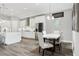 Bright kitchen with white cabinets, stainless steel appliances, and a dining area near a window at 5477 Wayfarer Ave, Apollo Beach, FL 33572
