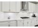 Modern kitchen featuring white subway tile backsplash, white cabinets and granite countertops at 5477 Wayfarer Ave, Apollo Beach, FL 33572