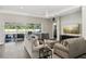 Inviting living room with hardwood floors, sliding glass doors to the patio, and comfortable seating arrangements at 5477 Wayfarer Ave, Apollo Beach, FL 33572