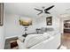 Cozy living room with plush seating, contemporary ceiling fan, and a wall-mounted TV at 5477 Wayfarer Ave, Apollo Beach, FL 33572
