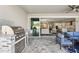 A cozy covered patio with outdoor kitchen and view into the living room and kitchen via sliding glass doors at 5477 Wayfarer Ave, Apollo Beach, FL 33572