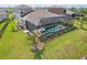 Screened-in pool and lush landscaping, creating a private backyard oasis at 5477 Wayfarer Ave, Apollo Beach, FL 33572