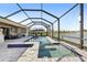 Beautiful screened-in pool with a lake view is perfect for cooling off on hot days at 5477 Wayfarer Ave, Apollo Beach, FL 33572