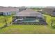 Aerial view of a backyard with a screened-in pool, spa and landscaped yard at 5477 Wayfarer Ave, Apollo Beach, FL 33572