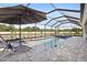 Enjoy the view from the screened-in pool, with lounge chairs and umbrella at 5477 Wayfarer Ave, Apollo Beach, FL 33572
