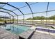 Relax and enjoy the lake view from this screened-in pool and spa at 5477 Wayfarer Ave, Apollo Beach, FL 33572