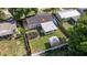 Aerial view of a home with fenced yard, fire pit, patio, and storage shed at 5932 Mckee Lake N Dr, St Petersburg, FL 33709
