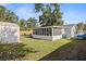 Spacious backyard with screened in patio, tool shed, and outdoor seating at 5932 Mckee Lake N Dr, St Petersburg, FL 33709