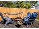 Backyard with wood fence, Adirondack chairs, fire pit and hammock creates a relaxing space at 5932 Mckee Lake N Dr, St Petersburg, FL 33709
