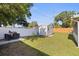 Backyard features include a grill, a tool shed, and a white fence at 5932 Mckee Lake N Dr, St Petersburg, FL 33709