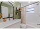Bright bathroom with new hardware, modern mirror, and tiled shower at 5932 Mckee Lake N Dr, St Petersburg, FL 33709