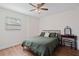 This cozy bedroom features a ceiling fan and hardwood floors at 5932 Mckee Lake N Dr, St Petersburg, FL 33709