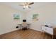 Bedroom featuring hardwood floors, ceiling fan, and lots of natural light at 5932 Mckee Lake N Dr, St Petersburg, FL 33709