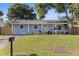 Inviting single-story home with a spacious front yard and charming curb appeal at 5932 Mckee Lake N Dr, St Petersburg, FL 33709