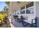 Charming front porch with cozy seating, plants, and view of the landscaped front yard at 5932 Mckee Lake N Dr, St Petersburg, FL 33709