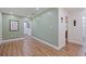 Hallway with neutral paint and modern laminate flooring at 5932 Mckee Lake N Dr, St Petersburg, FL 33709