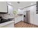 Modern kitchen with stainless steel appliances, white cabinets, and stylish countertops at 5932 Mckee Lake N Dr, St Petersburg, FL 33709