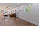 Bright living room featuring wood floors, a leather couch, and recessed lighting at 5932 Mckee Lake N Dr, St Petersburg, FL 33709