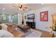 Open living room featuring a ceiling fan, modern furniture, and great natural light at 5932 Mckee Lake N Dr, St Petersburg, FL 33709