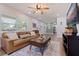 Cozy living room with a ceiling fan, modern furniture, and great natural light at 5932 Mckee Lake N Dr, St Petersburg, FL 33709