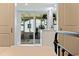 Bright main bedroom with sliders to the screened lanai and en suite bathroom at 5932 Mckee Lake N Dr, St Petersburg, FL 33709