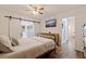 Bedroom with a ceiling fan, closet with sliding barn doors, and stylish furnishings at 5932 Mckee Lake N Dr, St Petersburg, FL 33709