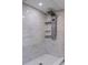 Updated shower featuring decorative tile and a multi-setting shower head at 5932 Mckee Lake N Dr, St Petersburg, FL 33709