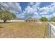 Expansive backyard featuring a well-maintained fence and a beautiful tree in a serene setting at 5939 14Th St, Zephyrhills, FL 33542