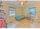 Bedroom featuring laminate flooring, a ceiling fan, and lots of natural light at 5939 14Th St, Zephyrhills, FL 33542