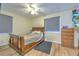 Bedroom featuring hardwood floors, a ceiling fan, and lots of natural light at 5939 14Th St, Zephyrhills, FL 33542