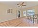Dining room with a ceiling fan, tile floors, lots of natural light, and a table and chairs at 5939 14Th St, Zephyrhills, FL 33542