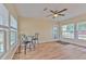 Bright dining area with windows, tiled floor, and a ceiling fan at 5939 14Th St, Zephyrhills, FL 33542