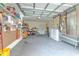 Organized garage featuring ample storage, laundry area, and workspace, perfect for projects and convenience at 5939 14Th St, Zephyrhills, FL 33542