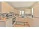 Cozy kitchen featuring white cabinetry, tiled backsplash, and a farmhouse sink at 5939 14Th St, Zephyrhills, FL 33542