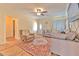 Inviting living room with hardwood floors, a large sectional, and a ceiling fan at 5939 14Th St, Zephyrhills, FL 33542