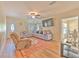 Bright living room featuring hardwood floors, neutral walls, and comfortable seating at 5939 14Th St, Zephyrhills, FL 33542