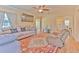Cozy living room with a large sectional sofa, ceiling fan, and hardwood flooring at 5939 14Th St, Zephyrhills, FL 33542