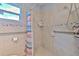Shower features neutral tiles and handrails for accessibility at 5939 14Th St, Zephyrhills, FL 33542