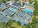 Aerial view showcasing a tennis and aquatics center with trees and recreational areas at 6104 Cognac Cir, Lutz, FL 33558