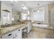 Bright bathroom with double vanity, soaking tub, and glass-enclosed shower at 6104 Cognac Cir, Lutz, FL 33558