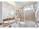 A bright bathroom features a shower-tub, a vanity, and neutral decor at 6104 Cognac Cir, Lutz, FL 33558