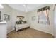 A bedroom with a daybed features a ceiling fan and a window at 6104 Cognac Cir, Lutz, FL 33558