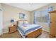 A cheerful bedroom features a ceiling fan and a window at 6104 Cognac Cir, Lutz, FL 33558