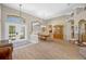 Spacious formal dining room featuring hardwood floors, a modern chandelier, and plenty of natural light at 6104 Cognac Cir, Lutz, FL 33558