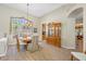 Formal dining room with a chandelier, a large window, and an ornate china cabinet at 6104 Cognac Cir, Lutz, FL 33558