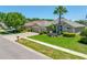 Charming home with a well-manicured lawn, a three-car garage, and a paver driveway at 6104 Cognac Cir, Lutz, FL 33558