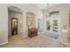Elegant foyer with hardwood floors, a high ceiling, arched doorways, and a decorative glass front door at 6104 Cognac Cir, Lutz, FL 33558