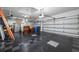 Spacious garage with checkered flooring, overhead lighting and ample storage space at 6104 Cognac Cir, Lutz, FL 33558